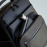 Memobottle water bottle in matching Lyra Camera backpack in black vegan leather