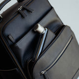 Memobottle water bottle in matching Lyra Camera backpack in black vegan leather