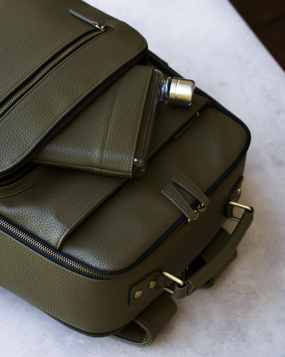 Memobottle water bottle in pocket with matching Lyra Camera backpack in olive vegan leather