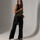 Photographer in studio wearing Versa Fanny Pack with camera strap