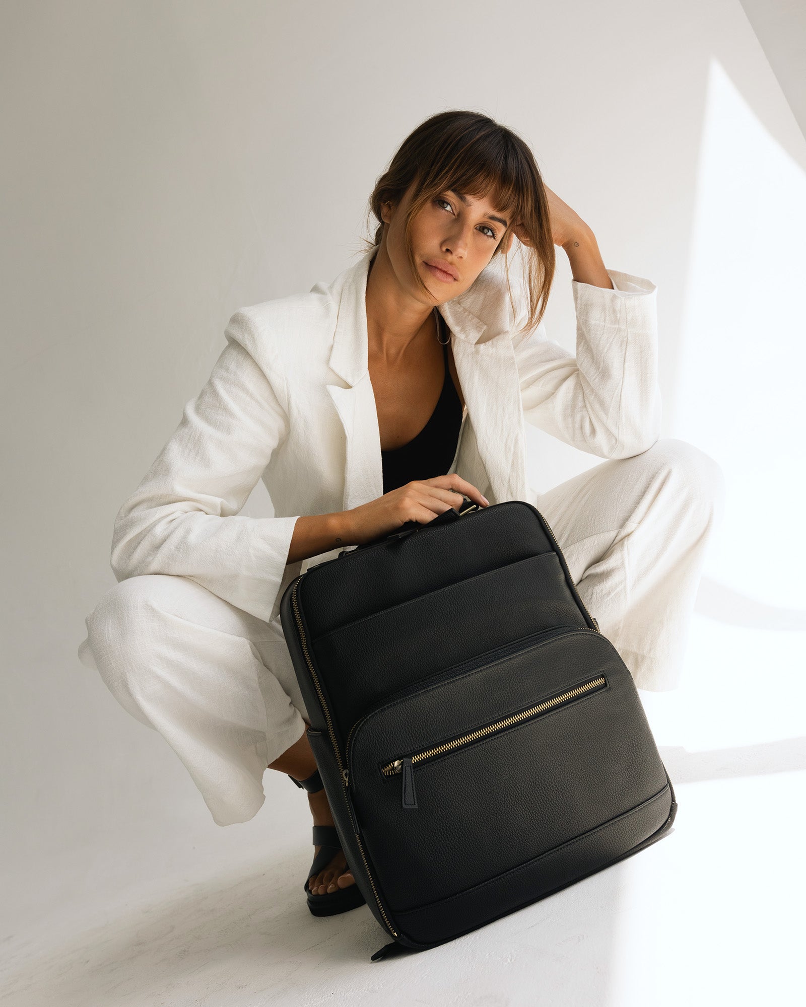 Woman photographer with Lyra camera backpack in photography studio