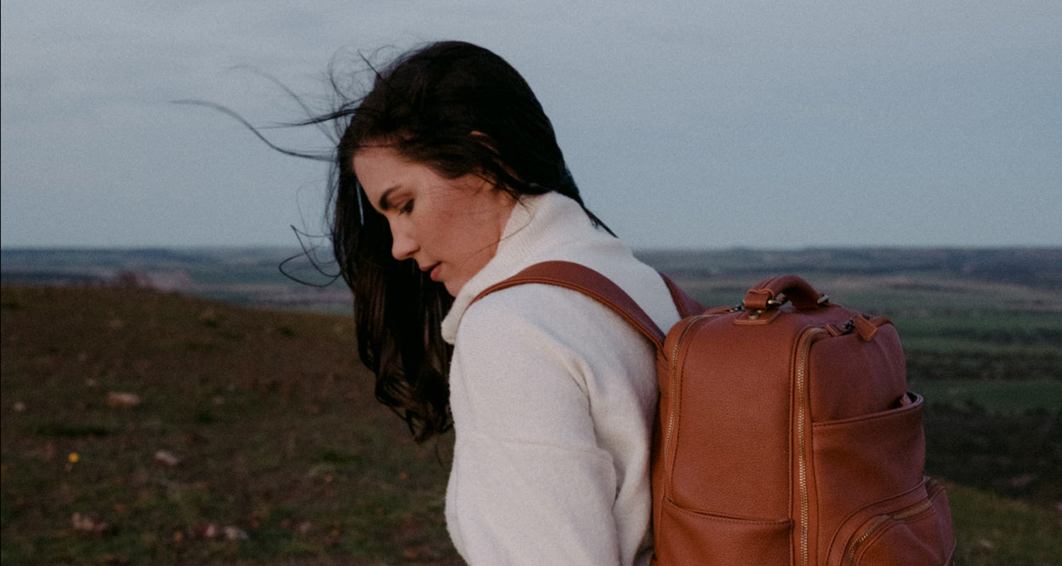 Photographer carrying a Lyra Camera Backpack in colour Tan