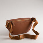 Back view of Versa Camera Crossbody in Tan with adjustable strap and secure storage