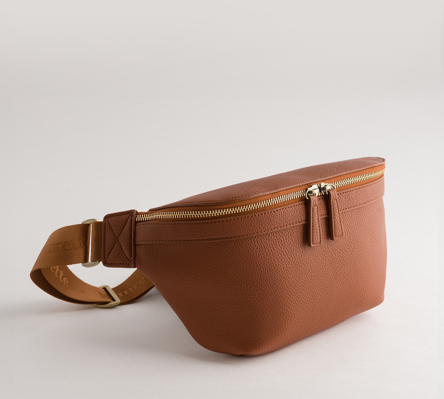 Versa Camera Crossbody - front view  of fanny pack in tan vegan leather