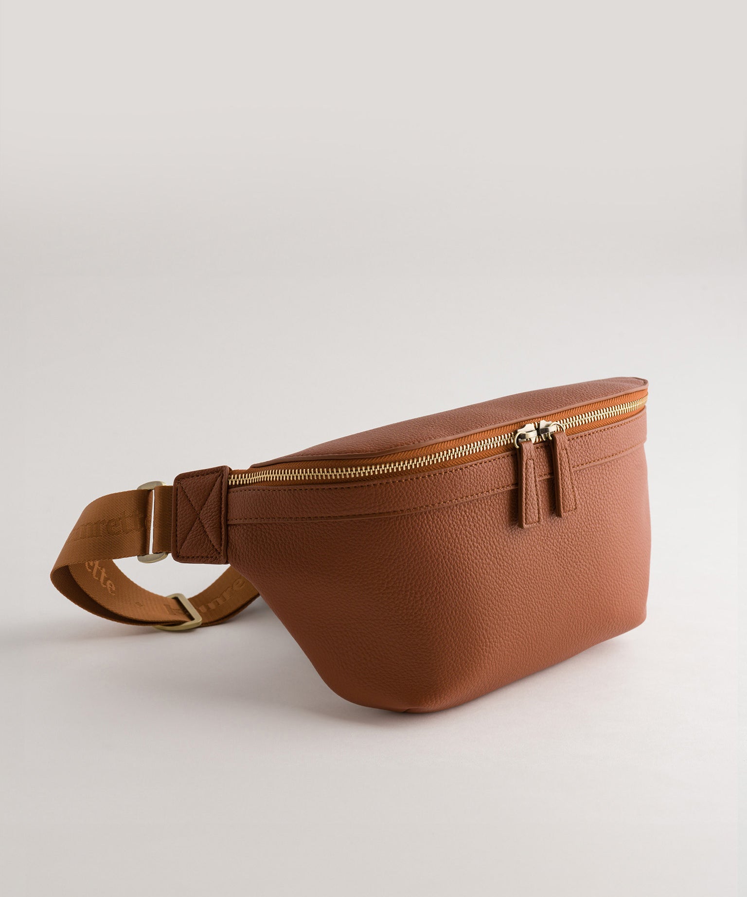 Versa Camera Crossbody - front view  of fanny pack in tan vegan leather