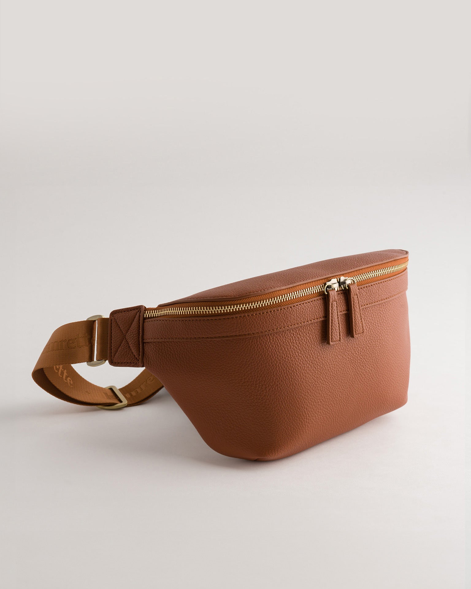 Versa Camera Crossbody - front view  of fanny pack in tan vegan leather