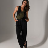 Woman photographer wearing Versa camera bag crossbody style wearing stylish travel clothes