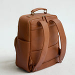 Back view of Lyra camera backpack in Tan with padded straps, laptop compartment and luggage sleeve
