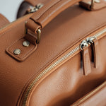 Vegan leather handle and aesthetic brushed brass hardware and zippers