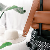 Travel luggage sleeve with Lyra Camera Bag sitting on suitcase 