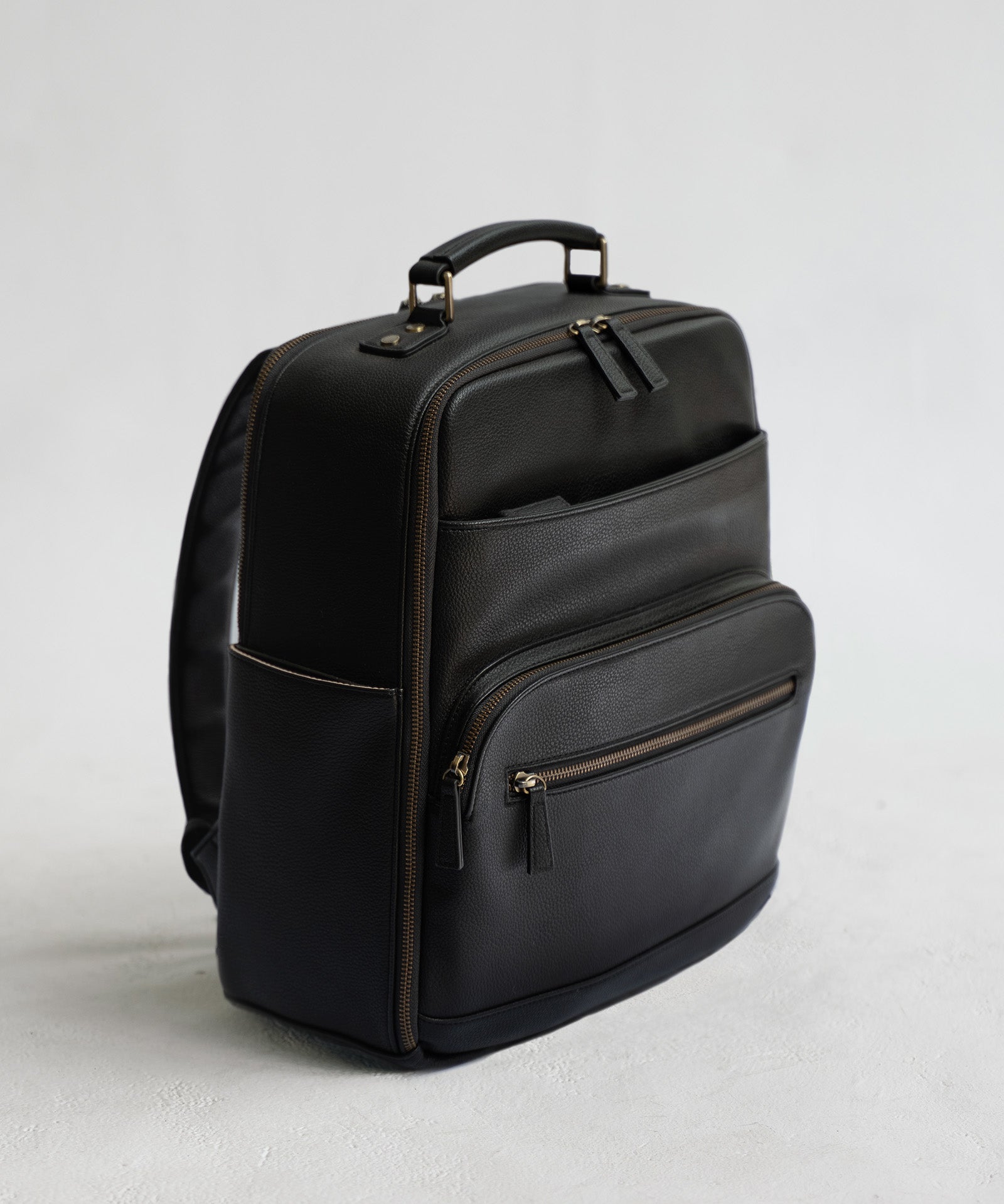 Lyra Camera Backpack - front view in black vegan leather