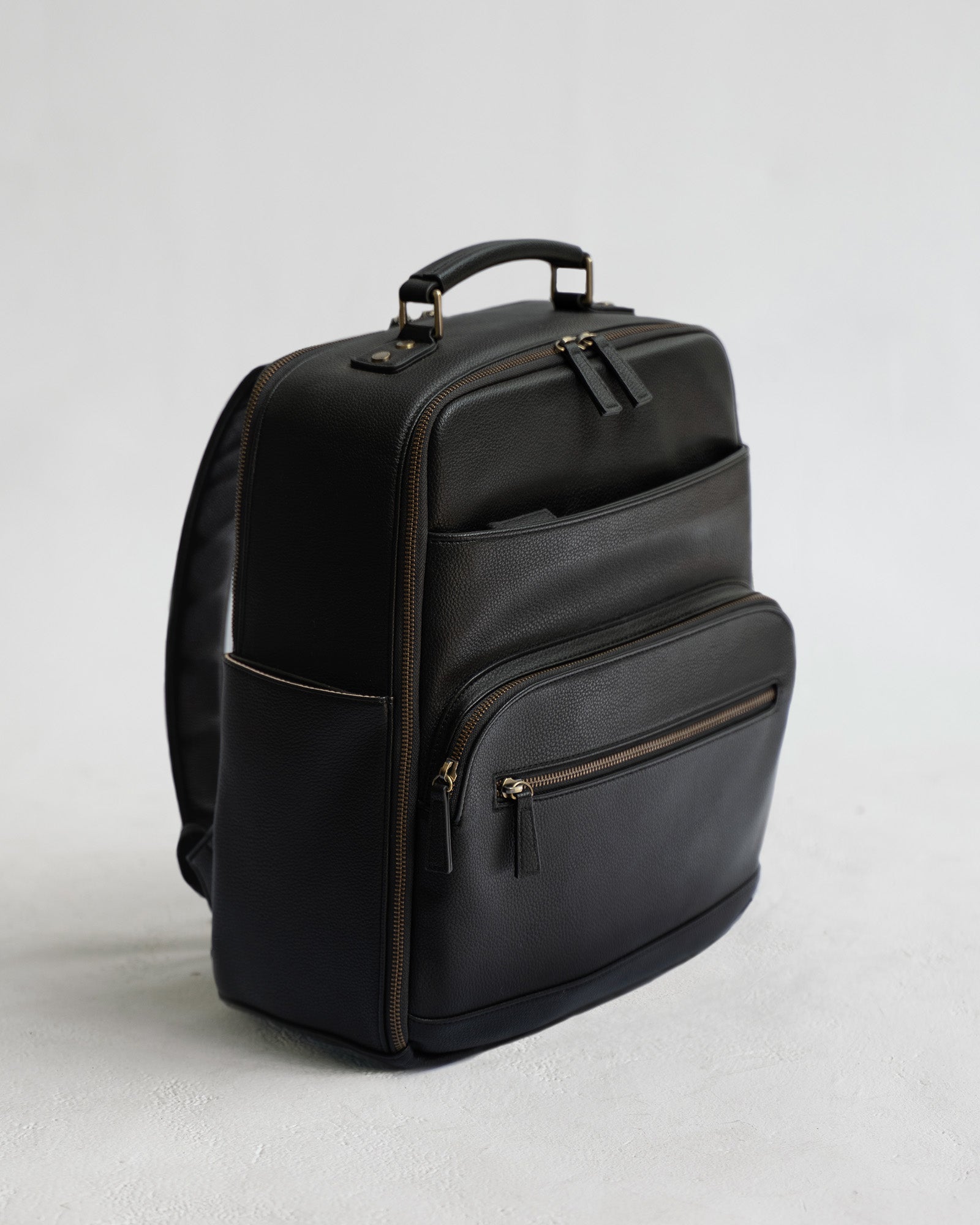 Lyra Camera Backpack - front view in black vegan leather