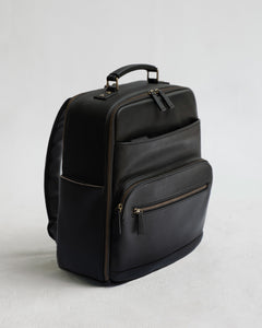 Lyra Camera Backpack - front view in black vegan leather