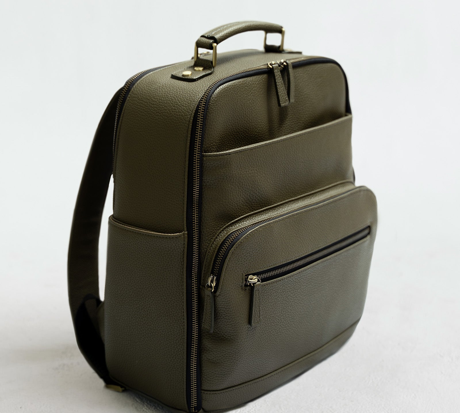 Lyra Camera Backpack - front view in olive vegan leather