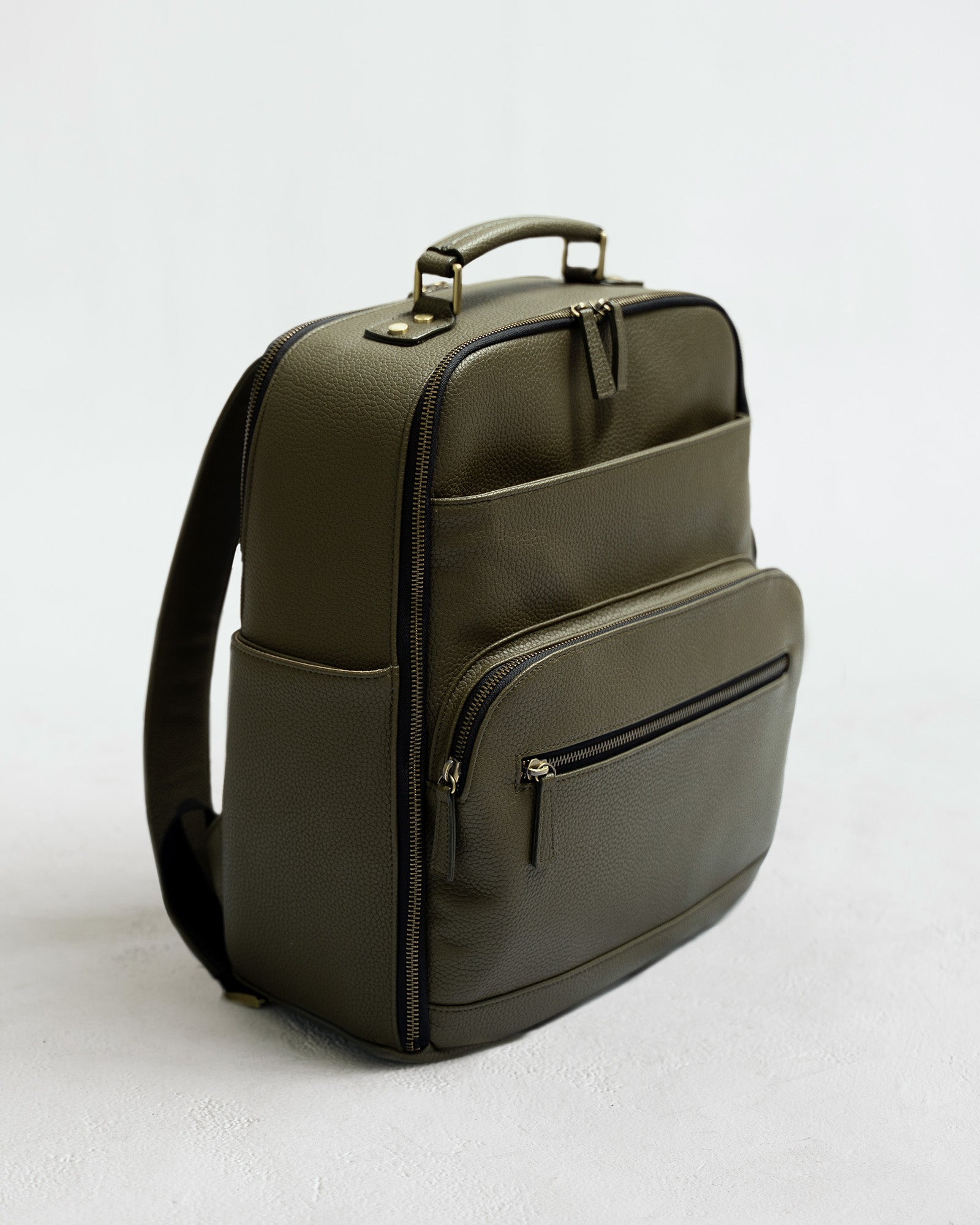 Lyra Camera Backpack - front view in olive vegan leather