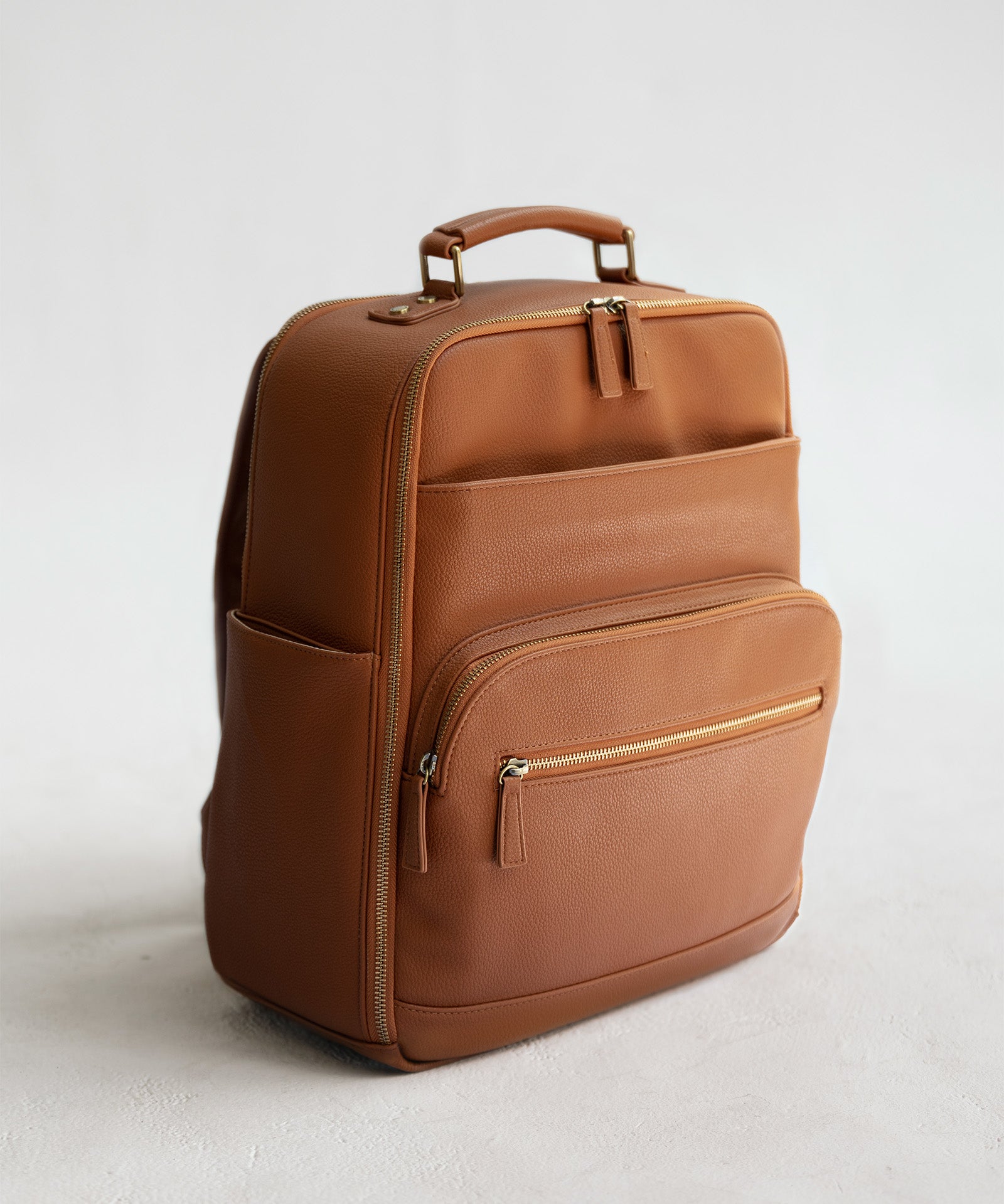 Lyra Camera Backpack - front view in tan vegan leather
