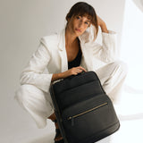 Woman photographer with Lyra camera backpack in photography studio