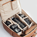 Lyra backpack open with DSLR, mirrorless camera, lenses and accessories
