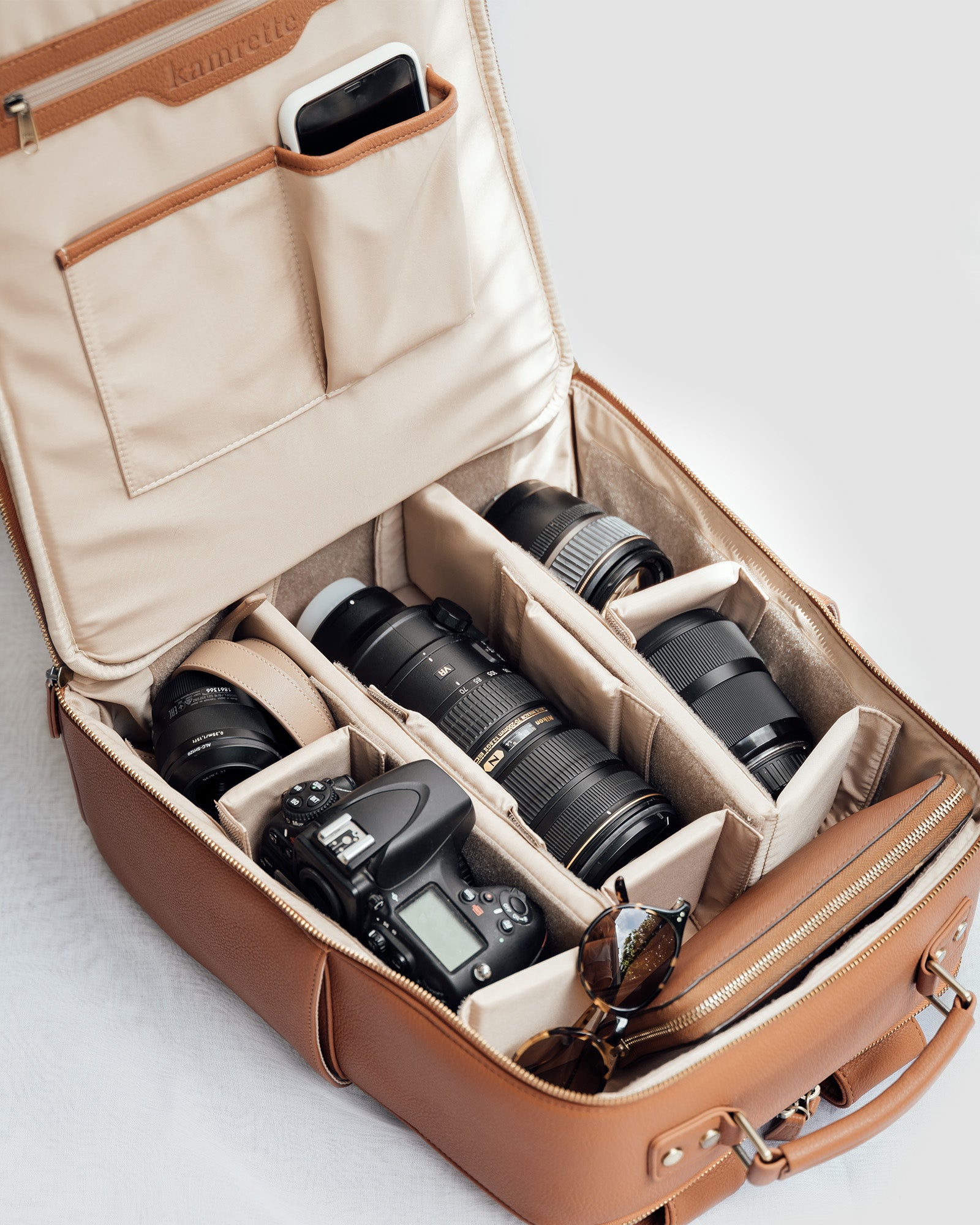 Lyra backpack open with DSLR, mirrorless camera, lenses and accessories