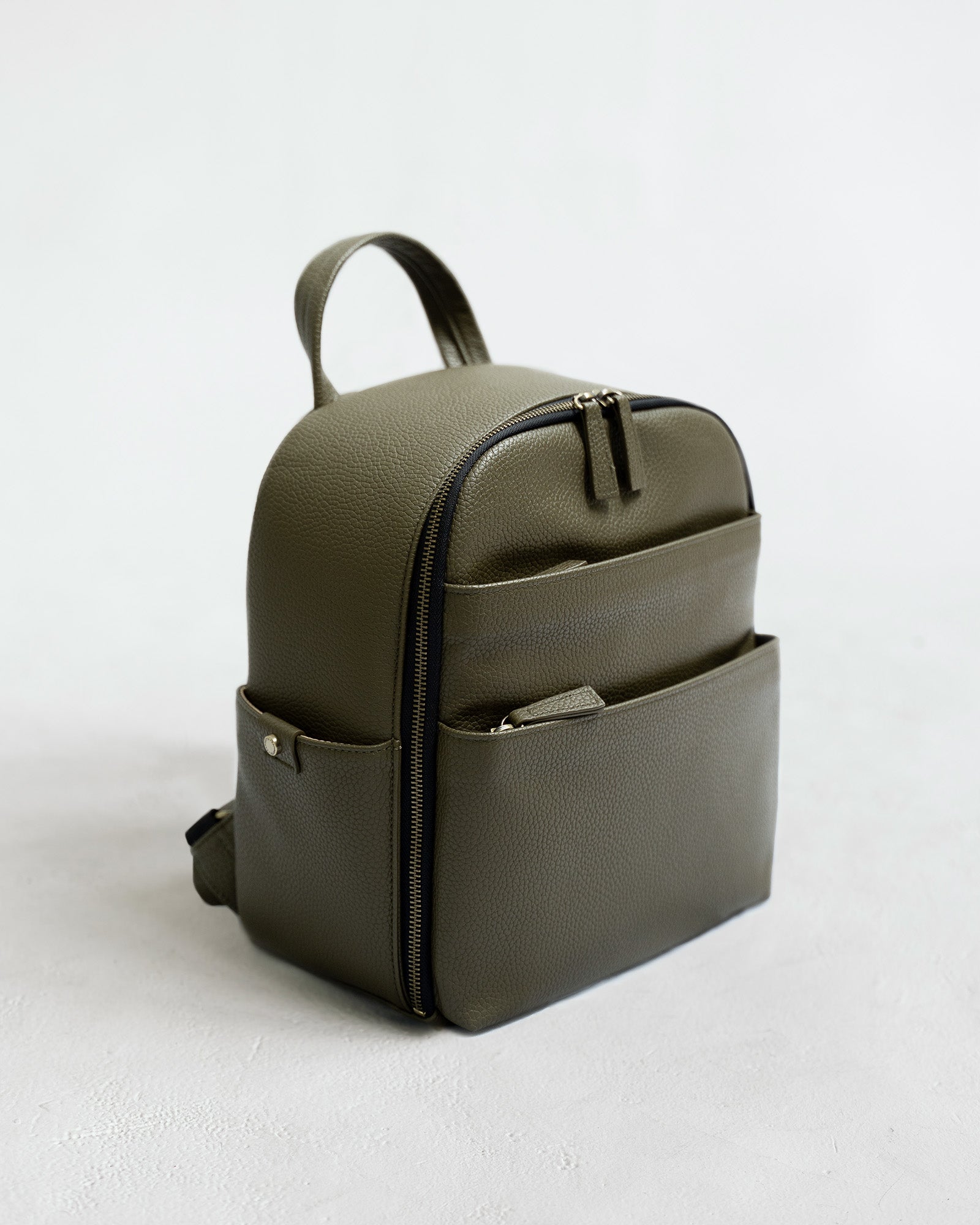Mina camera backpack in olive vegan leather – front view