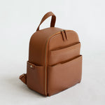 Mina Camera Backpack - front view in tan vegan leather and brushed brass hardware