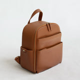 Mina Camera Backpack - front view in tan vegan leather and brushed brass hardware