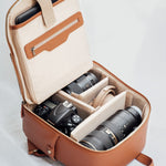 Mina backpack open with DSLR, mirrorless camera, lenses and accessories