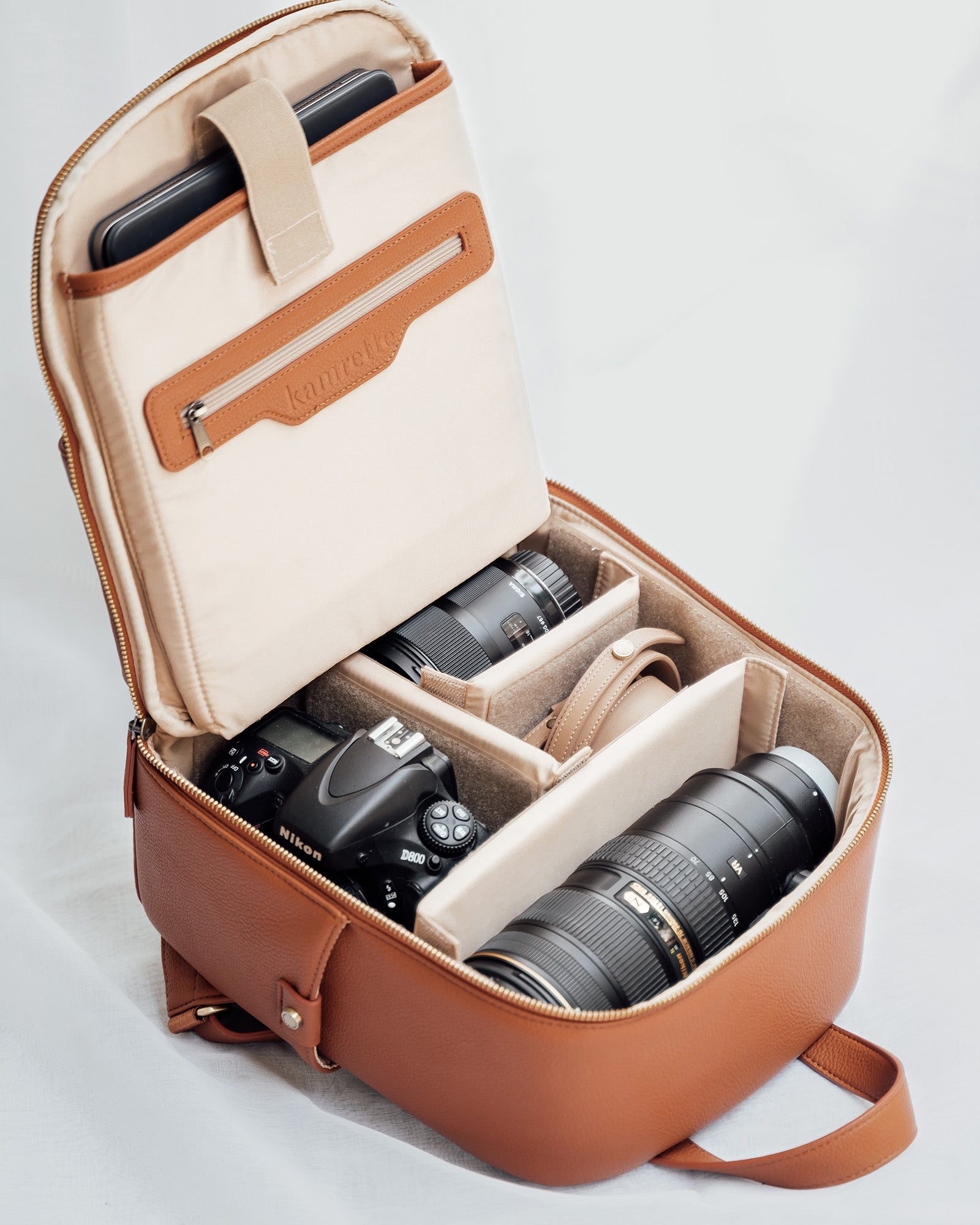Mina backpack open with DSLR, mirrorless camera, lenses and accessories